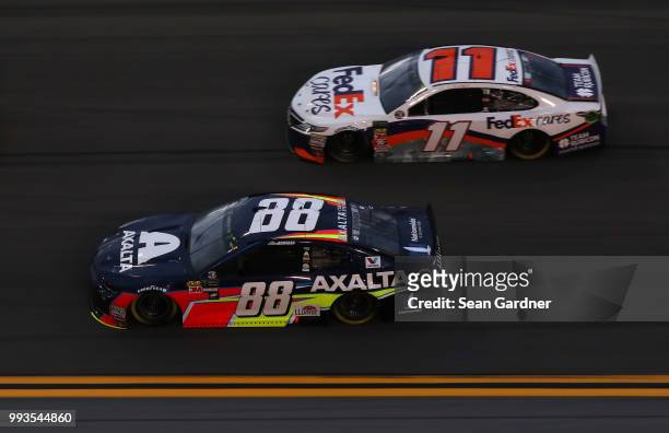 Alex Bowman, driver of the Axalta Chevrolet, leads Denny Hamlin, driver of the FexEx Cares Toyota, during the Monster Energy NASCAR Cup Series Coke...