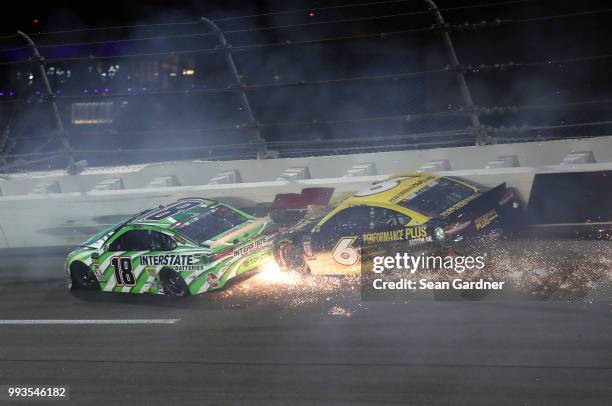 Kyle Busch, driver of the Interstate Batteries Toyota, and Trevor Bayne, driver of the Performance Plus Ford, are involved in an on-track incident...