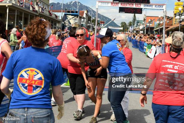 Tatjana Spaic receives assistance following her race during the Women's Division of the 91st Running of the Mount Marathon Race on July 4, 2018 in...