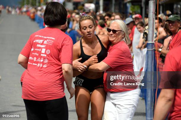 Zoe Hickel receives assistance following her race during the Women's Division of the 91st Running of the Mount Marathon Race on July 4, 2018 in...