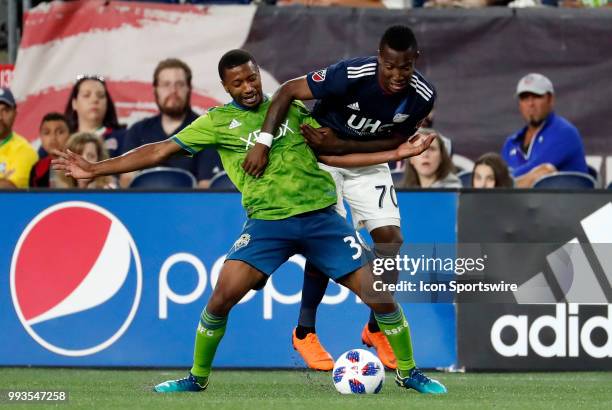 Seattle Sounders FC defender Jordan McCrary tries to hold off New England Revolution forward Cristian Penilla during a match between the New England...