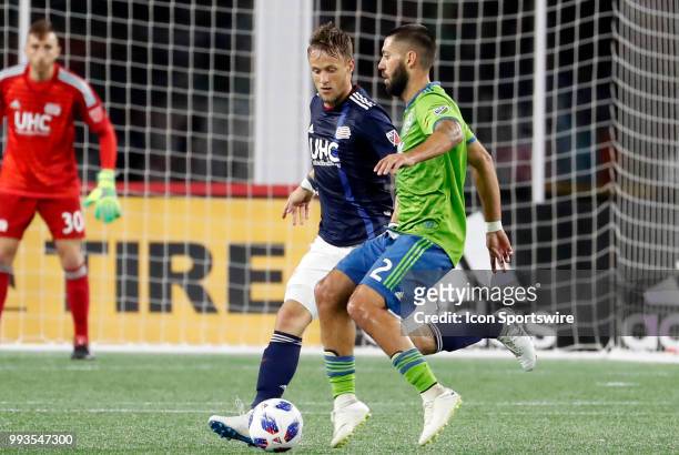 Seattle Sounders FC forward Clint Dempsey watched by New England Revolution defender Antonio Mlinar Delamea during a match between the New England...