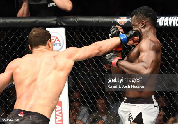 Paulo Costa of Brazil punches Uriah Hall of Jamaica in their middleweight fight during the UFC 226 event inside T-Mobile Arena on July 7, 2018 in Las...