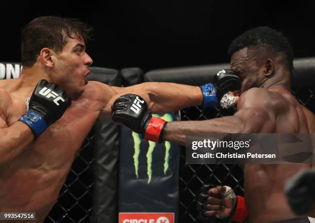 Paulo Costa of Brazil punches Uriah Hall of Jamaica in their middleweight fight during the UFC 226 event inside T-Mobile Arena on July 7, 2018 in Las...