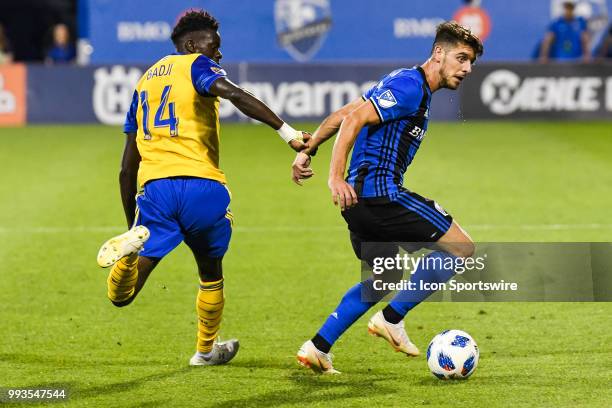 Montreal Impact midfielder Alejandro Silva gains control of the ball while chased by Colorado Rapids forward Dominique Badji during the Colorado...