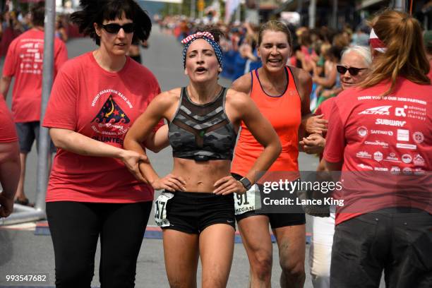 Sable Hodson and Megan Olson react following their race during the Women's Division of the 91st Running of the Mount Marathon Race on July 4, 2018 in...