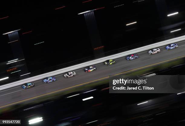 Michael McDowell, driver of the K-LOVE Radio Ford, leads a pack of cars during the Monster Energy NASCAR Cup Series Coke Zero Sugar 400 at Daytona...