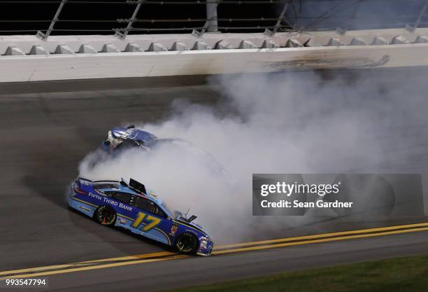 Ricky Stenhouse Jr., driver of the Fifth Third Bank Ford, and Kyle Larson, driver of the Credit One Bank Chevrolet, are involved in an on-track...