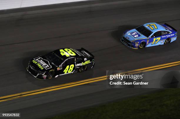 Jimmie Johnson, driver of the Lowe's for Pros Chevrolet, races Ricky Stenhouse Jr., driver of the Fifth Third Bank Ford, during the Monster Energy...