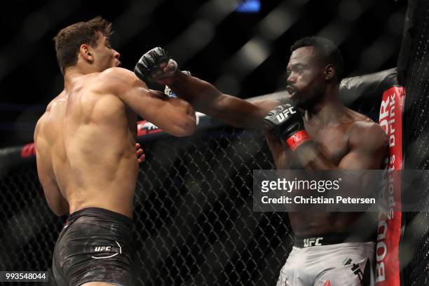 Uriah Hall of Jamaica punches Paulo Costa of Brazil in their middleweight fight during the UFC 226 event inside T-Mobile Arena on July 7, 2018 in Las...