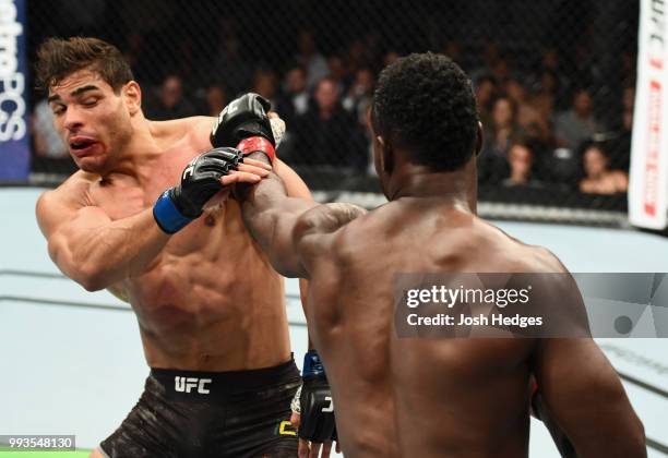 Uriah Hall of Jamaica punches Paulo Costa of Brazil in their middleweight fight during the UFC 226 event inside T-Mobile Arena on July 7, 2018 in Las...