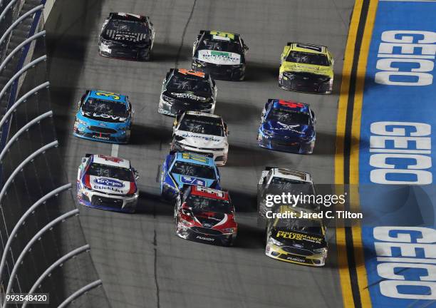 Trevor Bayne, driver of the Performance Plus Ford, and Matt DiBenedetto, driver of the Zynga Poker Ford, lead a pack of cars during the Monster...