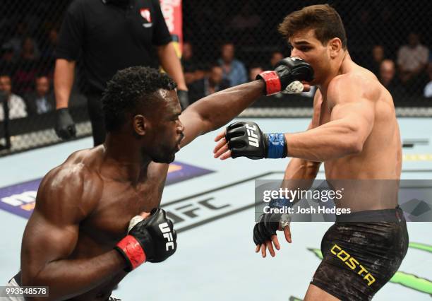 Uriah Hall of Jamaica punches Paulo Costa of Brazil in their middleweight fight during the UFC 226 event inside T-Mobile Arena on July 7, 2018 in Las...