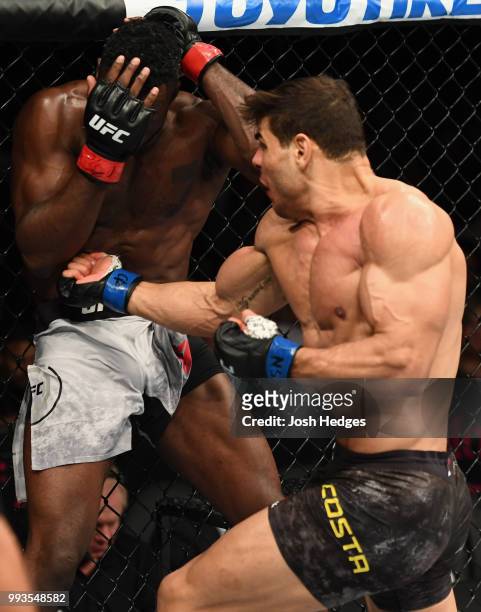 Paulo Costa of Brazil punches Uriah Hall of Jamaica in their middleweight fight during the UFC 226 event inside T-Mobile Arena on July 7, 2018 in Las...