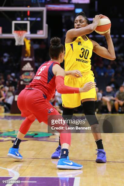 Nneka Ogwumike of the Los Angeles Sparks handles the ball against Natasha Cloud of the Washington Mystics during a WNBA basketball game at Staples...