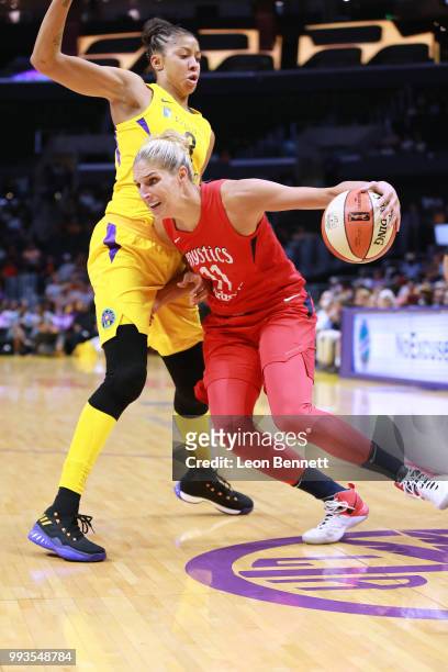 Elena Delle Donne of the Washington Mystics handles the ball against Candace Parker of the Los Angeles Sparks during a WNBA basketball game at...