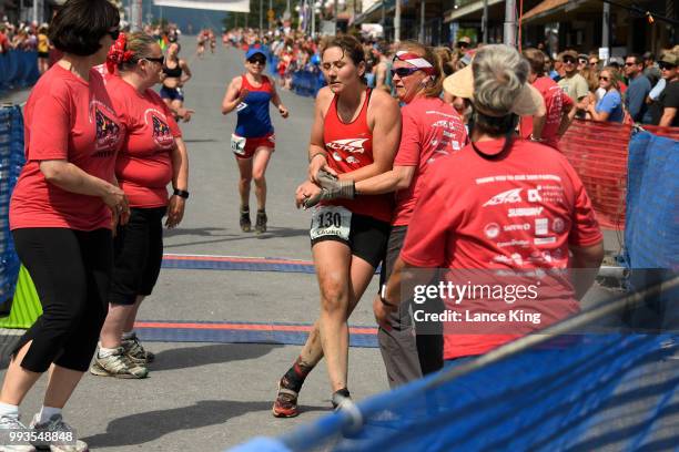 Laurel DeVore receives assistance following her race during the Women's Division of the 91st Running of the Mount Marathon Race on July 4, 2018 in...