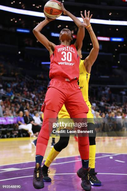 LaToya Sanders of the Washington Mystics handles the ball against Candace Parker of the Los Angeles Sparks during a WNBA basketball game at Staples...