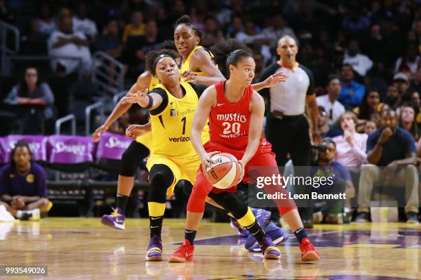 Kristi Toliver of the Washington Mystics handles the ball against Odyssey Sims of the Los Angeles Sparks during a WNBA basketball game at Staples...