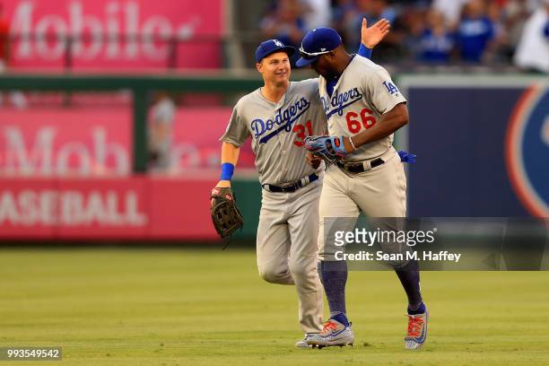 Joc Pederson congratulates Yasiel Puig of the Los Angeles Dodgers after defeating the Los Angeles Angels of Anaheim 3-1 in a game at Angel Stadium on...