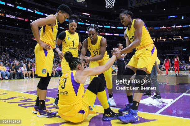 Alana Beard, Odyssey Sims, Chelsea Gray, Nneka Ogwumike after a hard foul help up Candace Parker of the Los Angeles Sparks against the Washington...