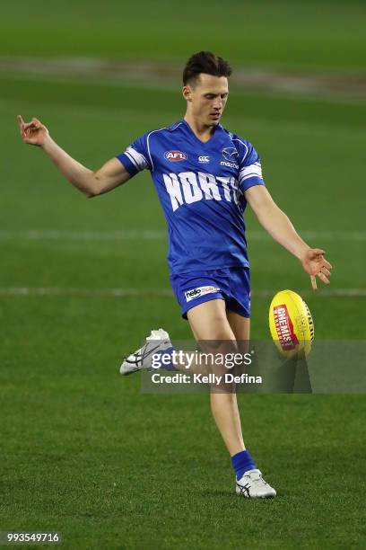 Ben Jacobs of the Kangaroos kicks the ball while warming up prior to the round 16 AFL match between the North Melbourne Kangaroos and the Gold Coast...