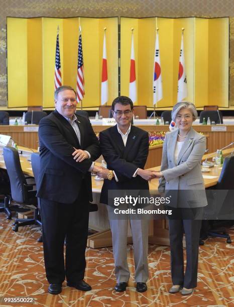 Mike Pompeo, U.S. Secretary of state, from left, Taro Kono, Japan's foreign minister, and Kang Kyung-wha, South Korea's foreign minister, shake hands...