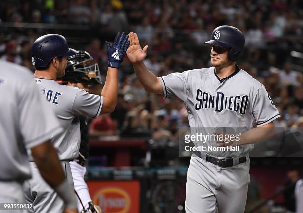 Wil Myers of the San Diego Padres is congratulated by teammates after hitting a two run home run during the first inning against the Arizona...