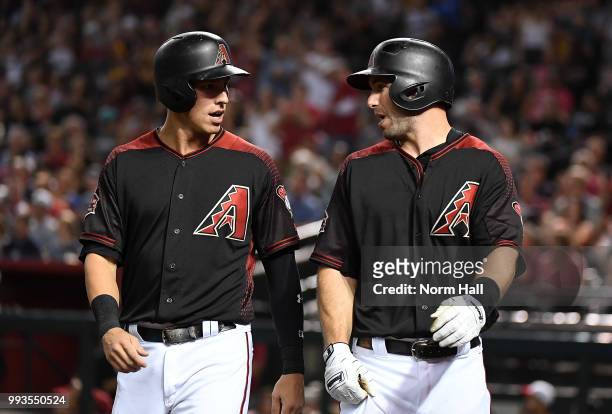 Paul Goldschmidt and Jake Lamb of the Arizona Diamondbacks celebrate after scoring on a double by teammate Daniel Descalso during the first inning...