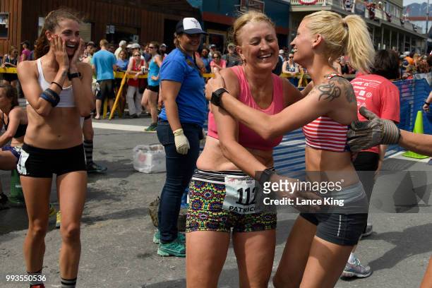Denali Foldager-Strabel reacts as Patricia Foldager and Rubye Foldager celebrate following their race during the Women's Division of the 91st Running...