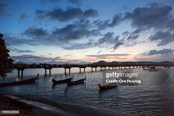 The sun rises over Chalong Pier, the rescue site of the capsized tourist boat Phoenix on July 8, 2018 in Phuket, Thailand. At least 41 people drowned...