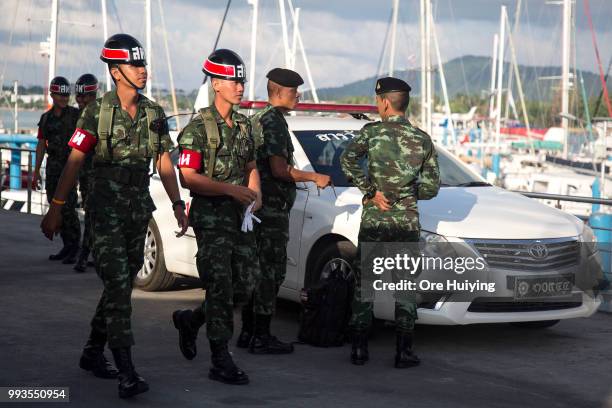 Royal Thai Army members gather at Chalong Pier on the fourth day of rescue operation of the capsized tourist boat Phoenix on July 8, 2018 in Phuket,...