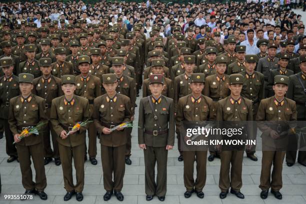 Korean People's Army soldiers stand before the statues of late North Korean leaders Kim Il Sung and Kim Jong Il, to mark the 24th anniversary of the...