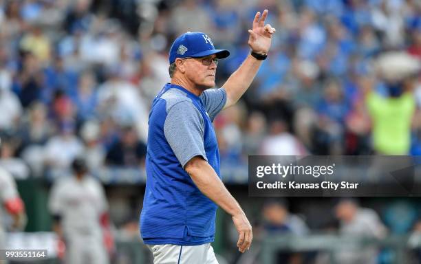 Kansas City Royals manager Ned Yost signals for Kansas City Royals relief pitcher Tim Hill to replace starting pitcher Brad Keller in the fifth...