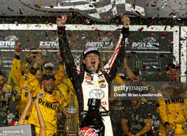 Erik Jones, driver of the buyatoyota.com Toyota, celebrates in Victory Lane after winning the Monster Energy NASCAR Cup Series Coke Zero Sugar 400 at...