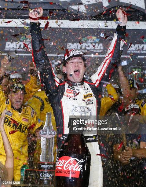 Erik Jones, driver of the buyatoyota.com Toyota, celebrates in Victory Lane after winning the Monster Energy NASCAR Cup Series Coke Zero Sugar 400 at...