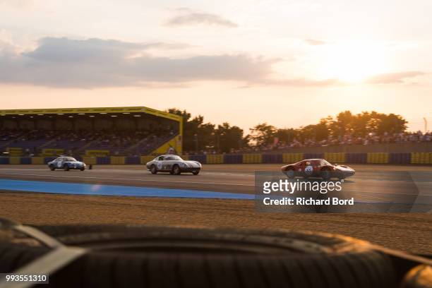 Porsche 904 Carrera GTS 1964 and a Ferrari 275 GTB 1964 compete during the Grid 4 Race 1 at Le Mans Classic 2018 on July 7, 2018 in Le Mans, France.