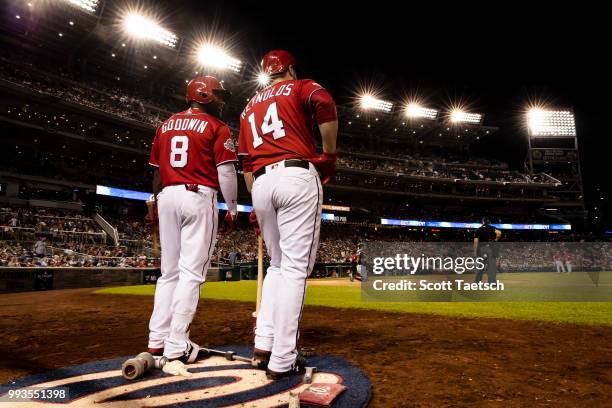 Brian Goodwin and Mark Reynolds of the Washington Nationals stand in the batters circle during the seventh inning against the Miami Marlins at...