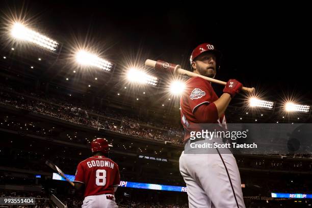 Brian Goodwin and Mark Reynolds of the Washington Nationals stand in the batters circle during the seventh inning against the Miami Marlins at...