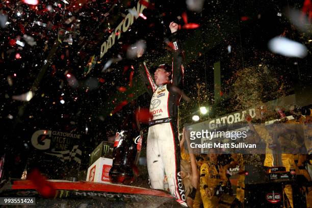 Erik Jones, driver of the buyatoyota.com Toyota, celebrates in Victory Lane after winning the Monster Energy NASCAR Cup Series Coke Zero Sugar 400 at...