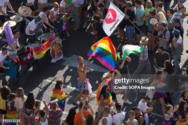 Participants seen marching with rainbow flags during the gay parade. Thousands of people have participated the Gay Pride 2018 in Madrid to against...