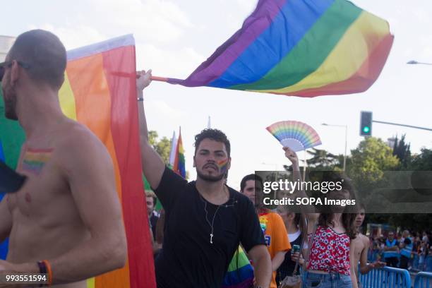 Participant with the LGTB flag during the parade. Thousands of people have participated the Gay Pride 2018 in Madrid to against LGBT phobia.