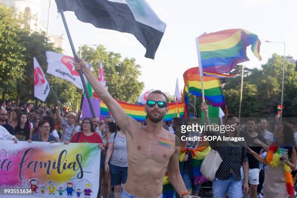 Topless participant shows an LGBT flag on his chest during the parade. Thousands of people have participated the Gay Pride 2018 in Madrid to against...