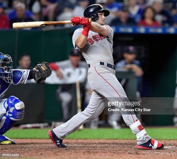 The Boston Red Sox's Andrew Benintendi follows through on a solo home run in the eighth inning against the Kansas City Royals at Kauffman Stadium in...
