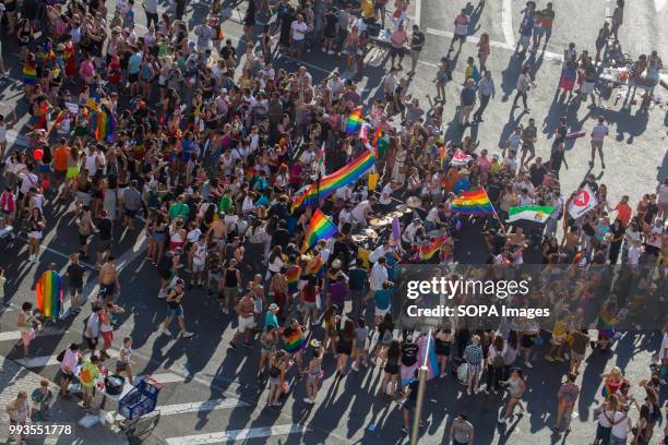 Participants seen marching with rainbow flags during the gay parade. Thousands of people have participated the Gay Pride 2018 in Madrid to against...