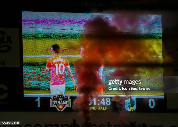 Plume of orange smoke rises above the pitch after the Houston Dynamo scored a goal during the soccer match between the Minnesota United FC and...