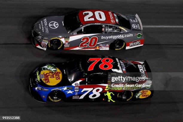 Martin Truex Jr., driver of the Bass Pro Shops/5-hour ENERGY Toyota, and Erik Jones, driver of the buyatoyota.com Toyota, race during the Monster...