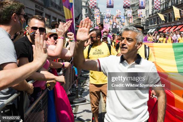 Mayor of London Sadiq Khan high-fives revellers lining Regents Street during Pride in London parade. The annual festival attracts hundreds of...