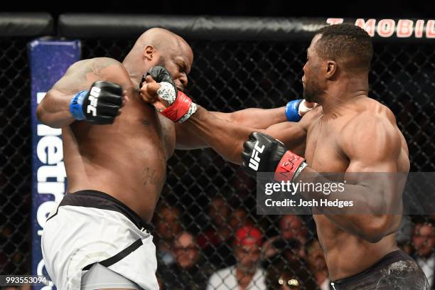 Francis Ngannou of Cameroon punches Derrick Lewis in their heavyweight fight during the UFC 226 event inside T-Mobile Arena on July 7, 2018 in Las...