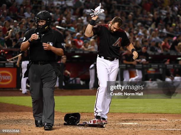 Steven Souza Jr of the Arizona Diamondbacks throws his batting gloves down after being called out on strikes by home plate umpire Manny Gonzalez...